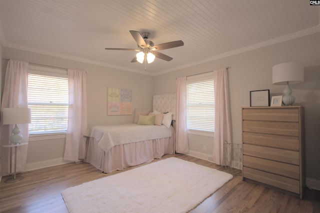 bedroom featuring baseboards, ornamental molding, ceiling fan, and wood finished floors