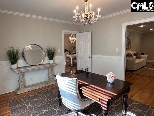 office with wainscoting, ornamental molding, a notable chandelier, and wood finished floors