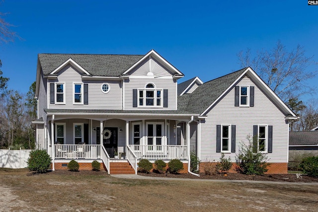 view of front facade with a shingled roof, covered porch, and crawl space