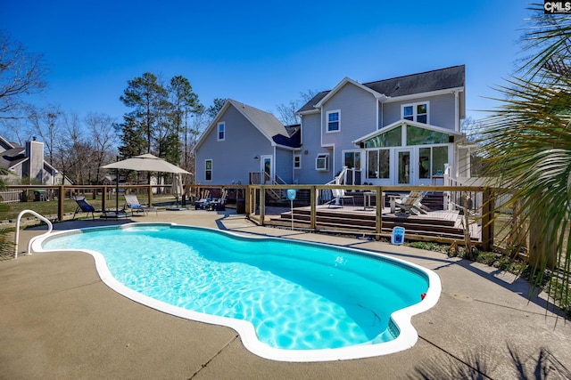 view of pool with a fenced in pool, a patio area, and a deck