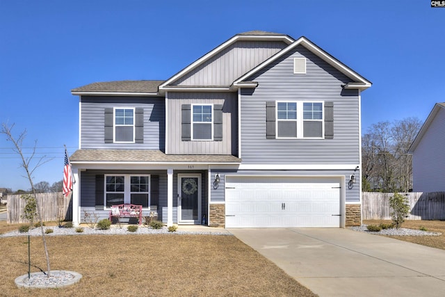 craftsman-style home with an attached garage, stone siding, and fence