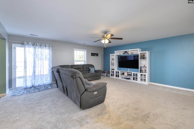 living area with baseboards, carpet, visible vents, and a ceiling fan