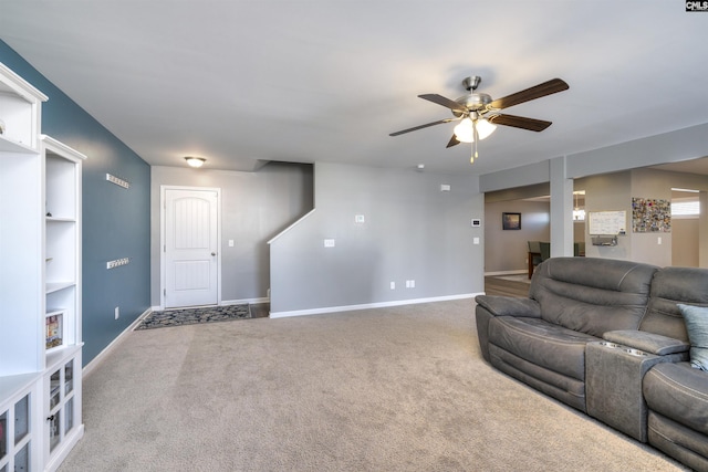 living area with carpet floors, ceiling fan, and baseboards