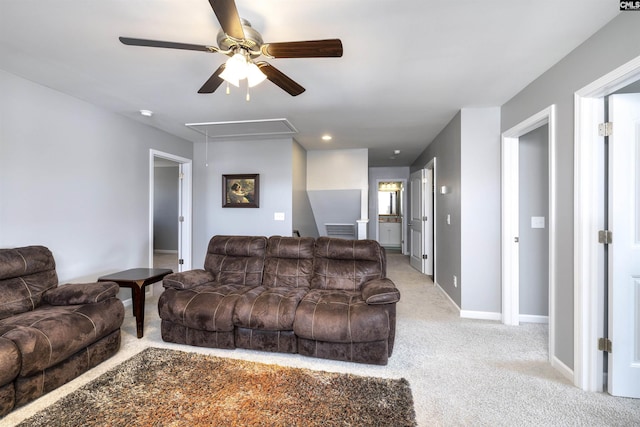 living room with attic access, light carpet, visible vents, and baseboards