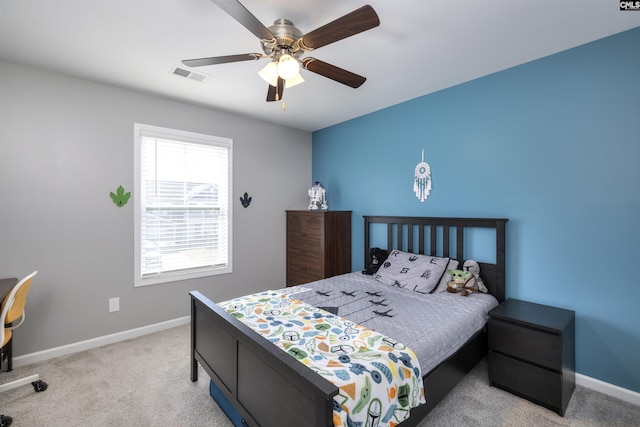 bedroom with ceiling fan, light colored carpet, visible vents, and baseboards