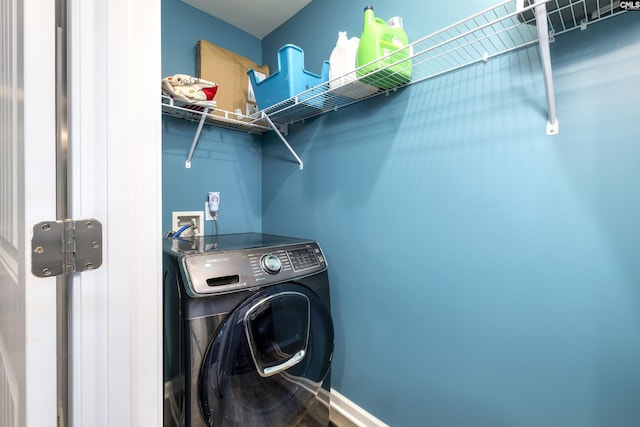 laundry area featuring washer / clothes dryer, baseboards, and laundry area