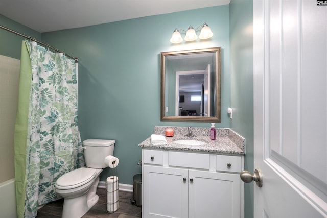 bathroom with baseboards, toilet, wood finished floors, shower / bath combo with shower curtain, and vanity