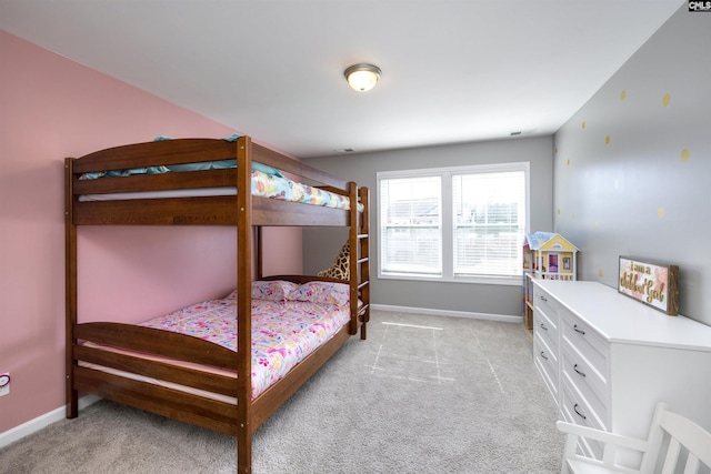 bedroom featuring light colored carpet and baseboards