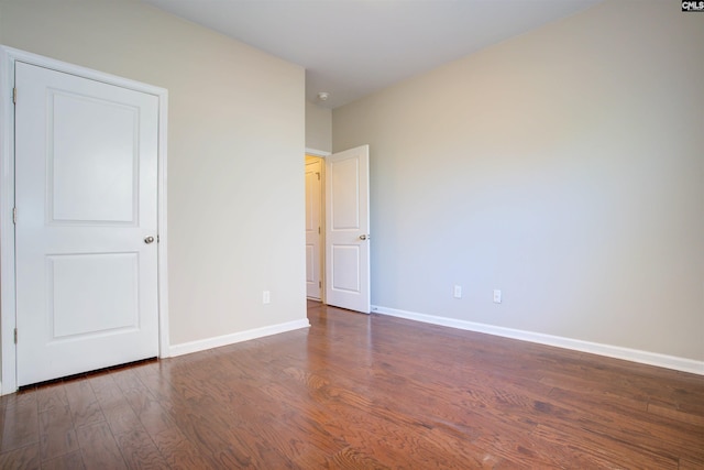 unfurnished bedroom with baseboards and wood finished floors