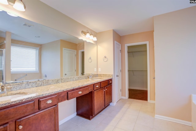 full bath featuring visible vents, a sink, a bath, and double vanity