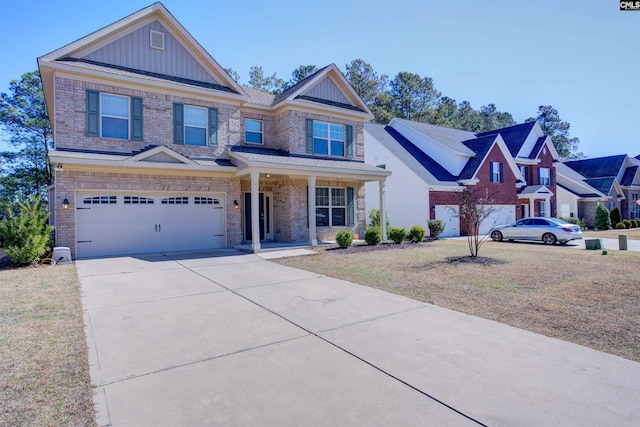 view of front facade featuring brick siding, concrete driveway, an attached garage, board and batten siding, and a front yard