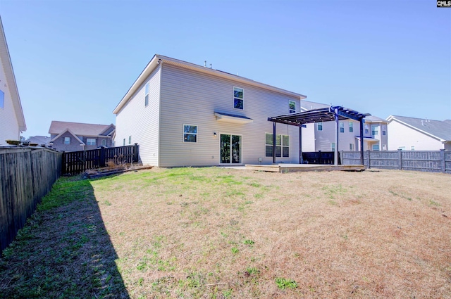 rear view of house featuring a lawn, a fenced backyard, and a pergola