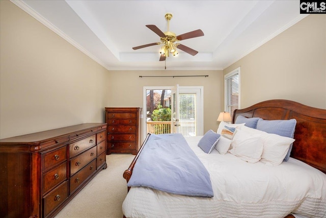 bedroom featuring access to exterior, crown molding, a raised ceiling, light colored carpet, and a ceiling fan