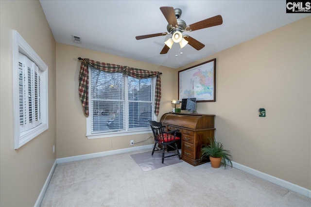 carpeted home office featuring ceiling fan, visible vents, and baseboards