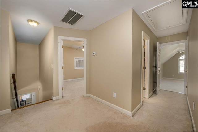 corridor with visible vents, carpet, attic access, and baseboards