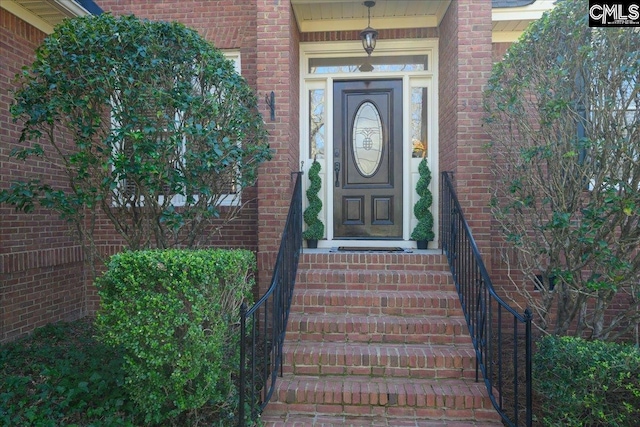 property entrance with brick siding