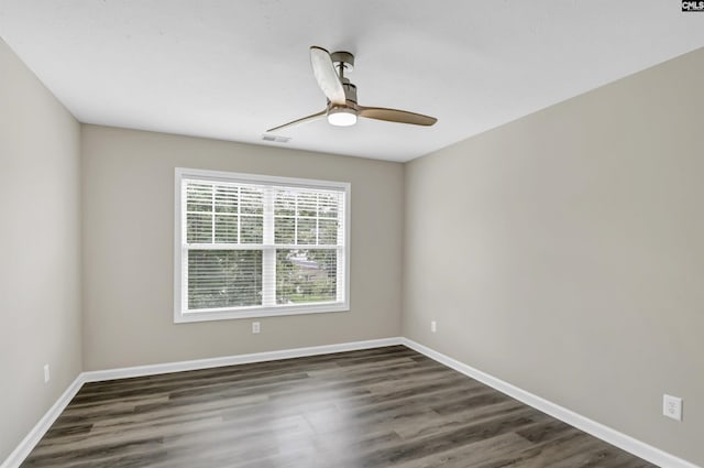 empty room featuring visible vents, baseboards, ceiling fan, and wood finished floors