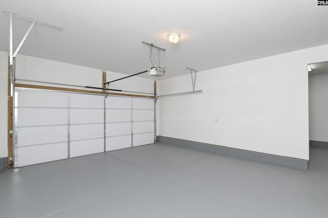 garage featuring baseboards and a garage door opener