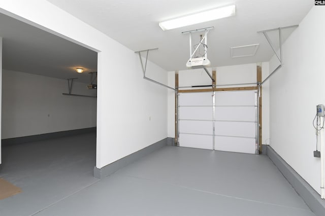 garage featuring a garage door opener and baseboards