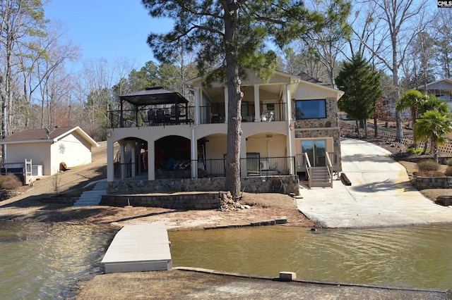 view of front of house featuring a balcony and stucco siding