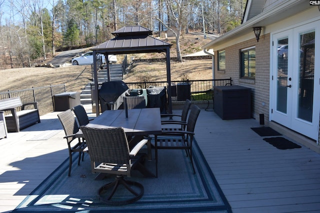 wooden deck featuring outdoor dining space, french doors, a gazebo, and central air condition unit