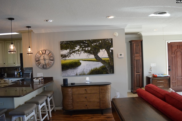 interior space featuring dark wood-style floors, visible vents, crown molding, and a textured ceiling