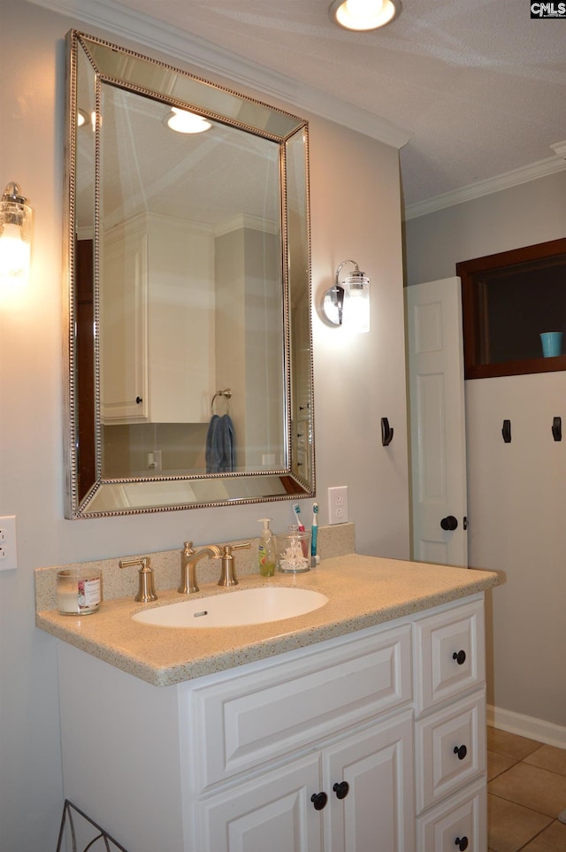 bathroom with ornamental molding, tile patterned flooring, and vanity