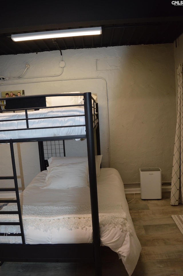 bedroom featuring wood finished floors