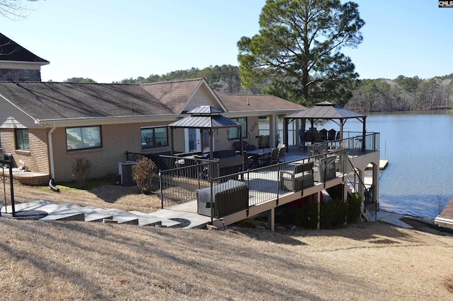 view of dock featuring central air condition unit, a water view, and a gazebo