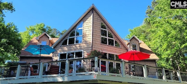 back of house featuring a wooden deck