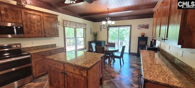 kitchen with plenty of natural light, stainless steel appliances, wooden ceiling, and beam ceiling