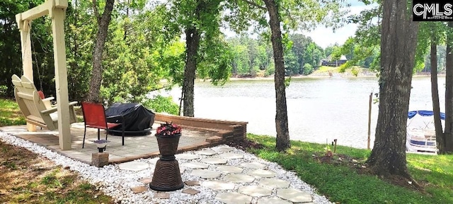 view of patio featuring grilling area and a water view