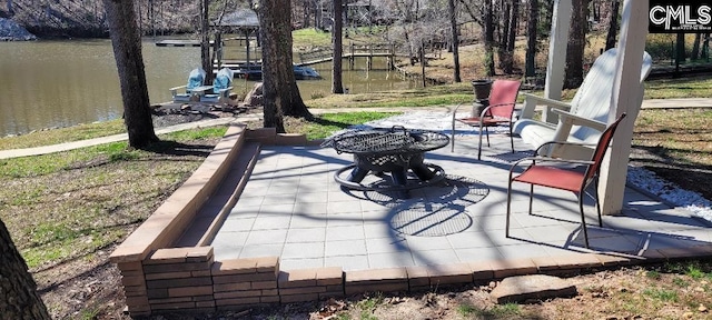 view of patio / terrace with a water view and a boat dock