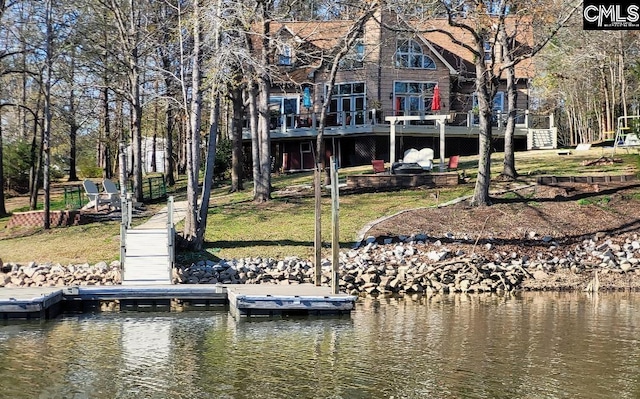 view of dock with a lawn and a deck with water view