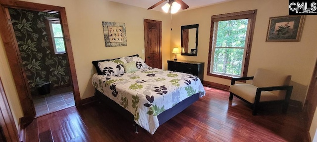 bedroom featuring dark wood-style floors and baseboards