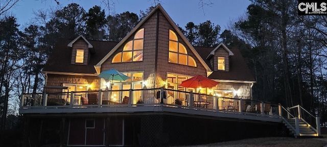 back of property featuring a wooden deck