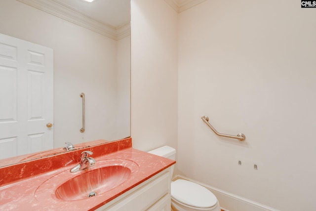 half bathroom with ornamental molding, vanity, and toilet