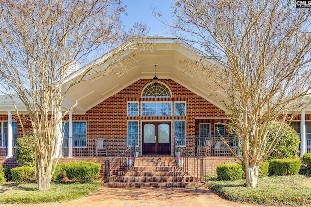 view of front of home featuring french doors and brick siding