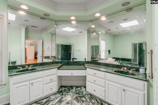 bathroom with marble finish floor, a skylight, ornamental molding, and vanity