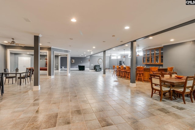 interior space with a community bar, light tile patterned floors, baseboards, and recessed lighting