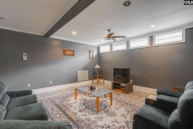 living area featuring visible vents, ornamental molding, ceiling fan, baseboards, and tile patterned floors