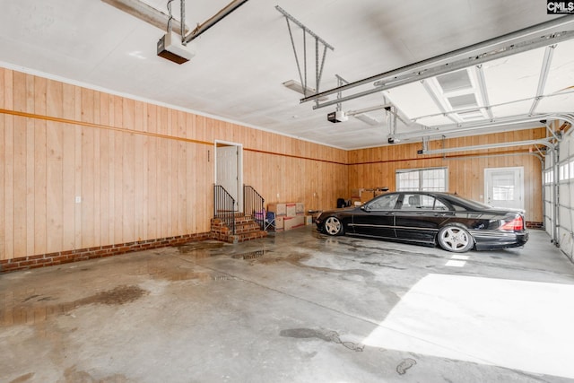 garage featuring wooden walls and a garage door opener