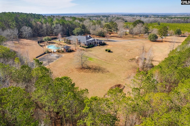 bird's eye view featuring a view of trees and a rural view