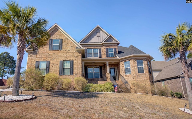 view of front of home with brick siding and board and batten siding