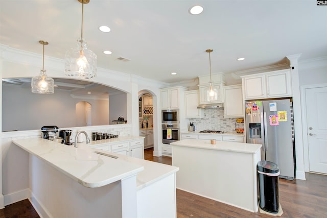 kitchen featuring appliances with stainless steel finishes, visible vents, ornamental molding, and a sink