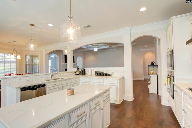 kitchen featuring visible vents, arched walkways, appliances with stainless steel finishes, dark wood-type flooring, and a sink