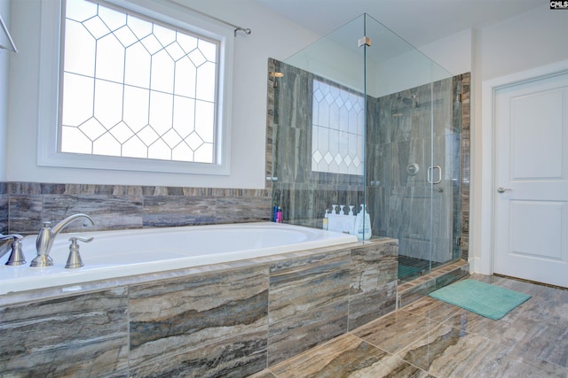 full bath featuring a stall shower and a garden tub