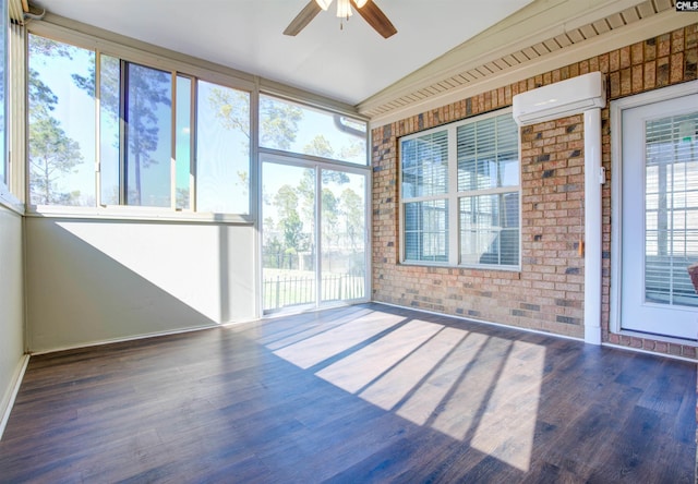 unfurnished sunroom featuring a ceiling fan and a wall mounted AC