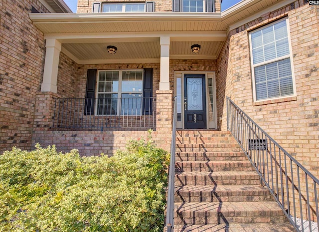 property entrance featuring brick siding