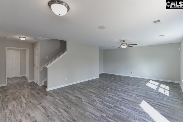 interior space featuring stairs, wood finished floors, visible vents, and baseboards